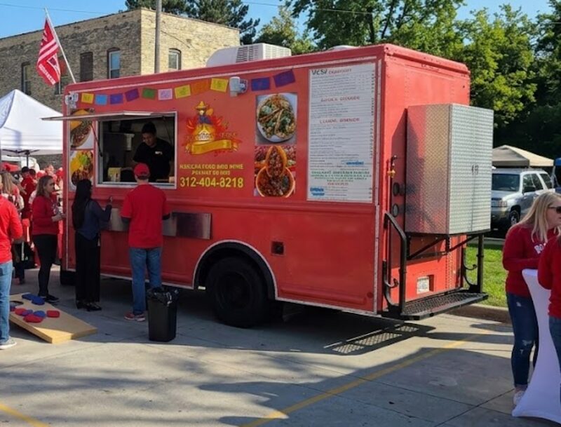 Food truck serving fans at a GameDay Your Way Badgers tailgate on Regent Street in Madison.