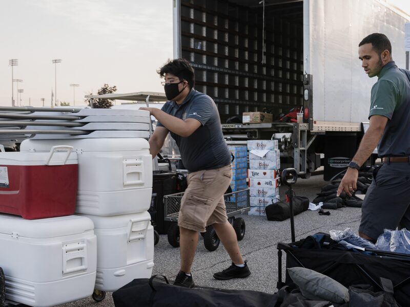 GameDay production team unloading tents, coolers and equipment for a Regent Street Fan Fest setup.