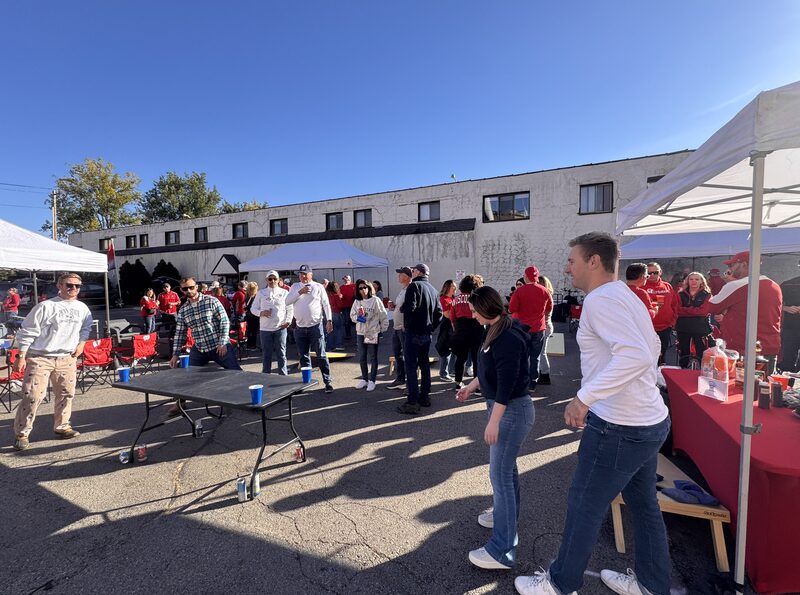 Badgers fans playing cornhole and mingling along Regent Street at the GameDay Fan Fest near Camp Randall.