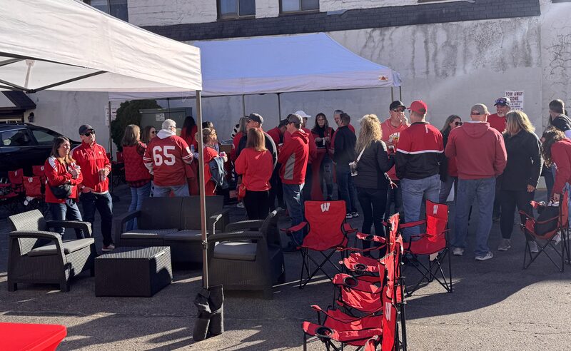 Wisconsin Badgers fans gathered under a tent along Regent Street at the GameDay Fan Fest in Madison.